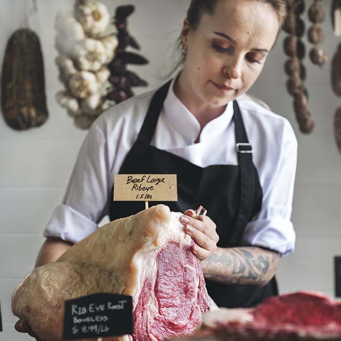 Butcher selling meat in a butcher shop food photography recipe idea